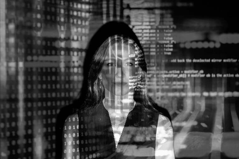 Silhouette of a person overlaid with binary code and programming scripts representing cryptocurrency fraud and blockchain forensic investigation